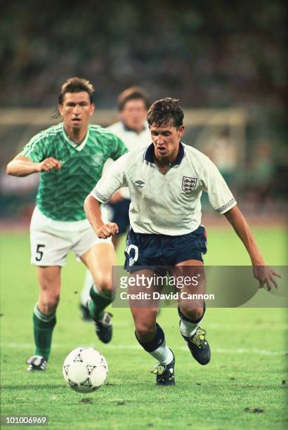 Klaus Augenthaler of the Federal Republic of Germany looks on as Gary Lineker of England goes past him during the FIFA World Cup Finals 1990...