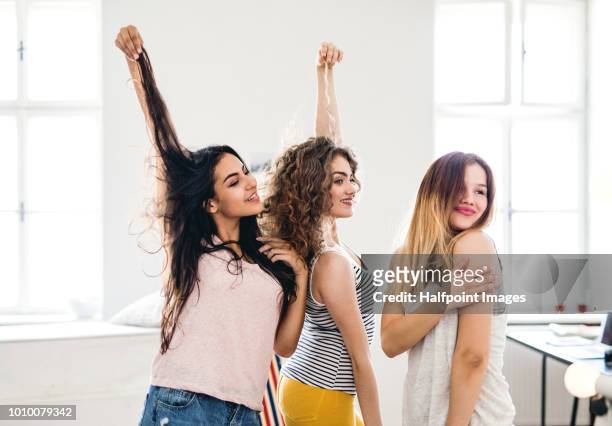 three female teenager friends looking in the mirror at home. - beautiful college girls stock pictures, royalty-free photos & images