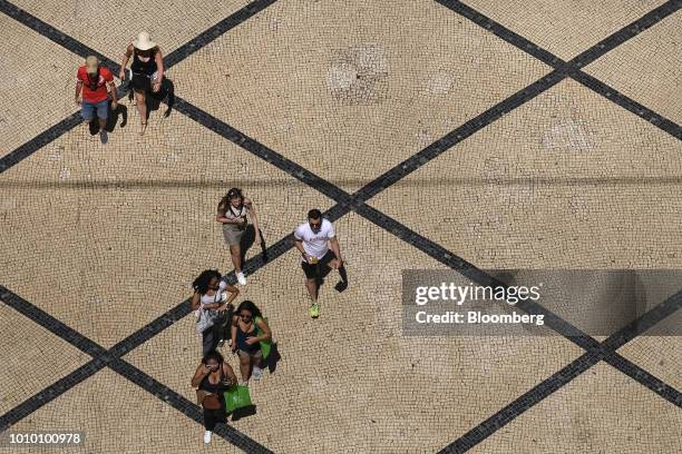 Pedestrians walk along Augusta Street in the Baixa district in Lisbon, Portugal, on Monday, July 30, 2018. The revival in Lisbons downtown property...