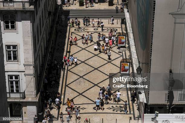 Pedestrians walk along Augusta street in the Baixa district of Lisbon, Portugal, on Monday, July 30, 2018. The revival in Lisbons downtown property...