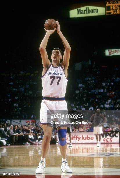 S: Center Gheorghe Muresan of the Washington Bullets shoots a free throw against the San Antonio Spurs circa mid 1990's during an NBA basketball game...