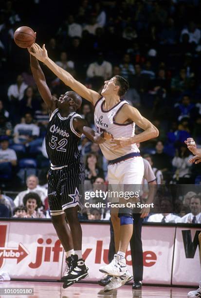 S: Center Gheorghe Muresan of the Washington Bullets battle for the ball with center Shaquille O'Neal of the Orlando Magic circa mid 1990's during an...