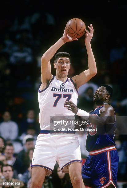 S: Center Gheorghe Muresan of the Washington Bullets is guarded closely by Patrick Ewing of the New York Knicks circa mid 1990's during an NBA...