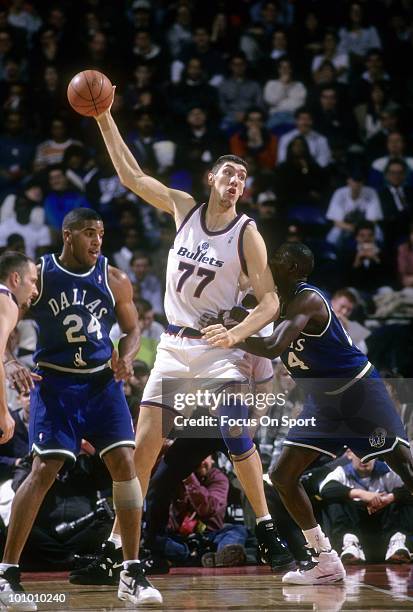 S: Center Gheorghe Muresan of the Washington Bullets backs in on center Lorenzo Williams of the Dallas Maverics circa mid 1990's during an NBA...