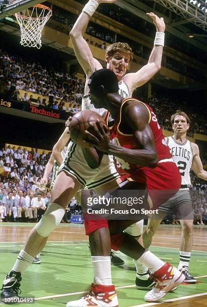 S: Hakeem Olajuwon of the Houston Rockets is guarded closely by Bill Walton of the Boston Celtics circa mid 1980's during an NBA basketball game at...