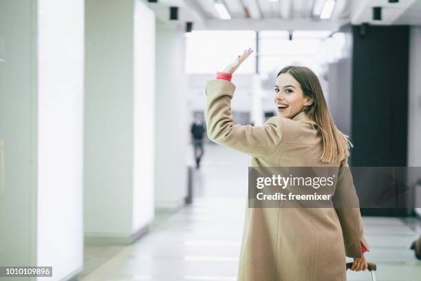 goodbye - woman waving stock pictures, royalty-free photos & images