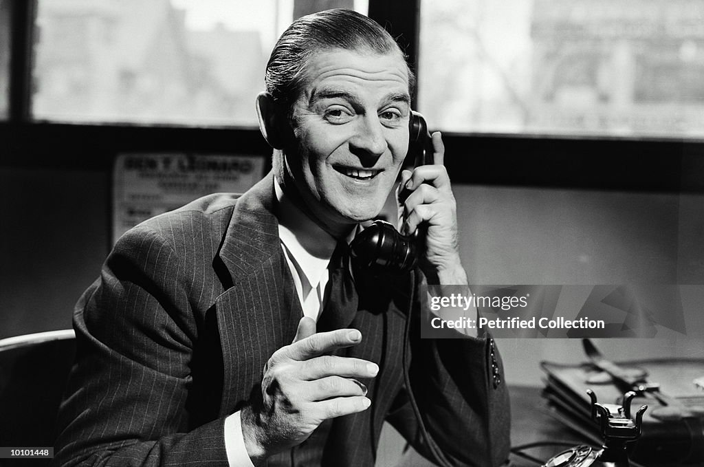 SMILING MAN ON TELEPHONE CIRCA 1940