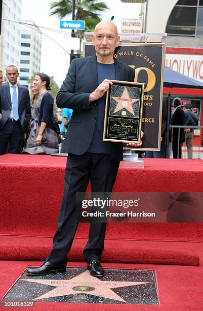 Actor Sir Ben Kingsley poses on his star after been honored with the 2,410th Star on the Hollywood Walk of Fame on May 27, 2010 in Hollywood,...