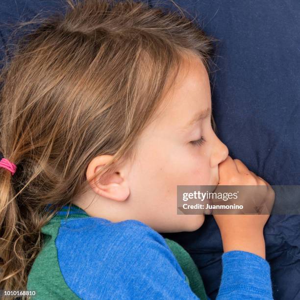 little girl sleeping sucking her thumb - thumb sucking stock pictures, royalty-free photos & images
