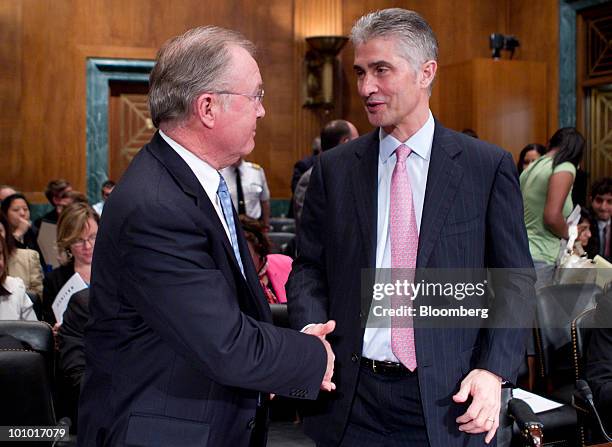 Glenn Tilton, chairman, president and chief executive officer of United Airlines, left, and Jeffery Smisek, chairman, president and chief executive...