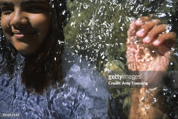Young woman cools off in the river November 19, 2000 in Adjuntas, Puerto Rico. Puerto Rico was an outpost of Spanish colonialism for 400 years, until...