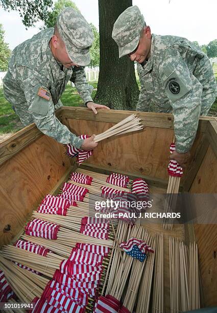 Members of the US Army 3rd US Infantrly Regiment, "The Old Guard," grab the last of thousands of flags to be placed at US military member's...