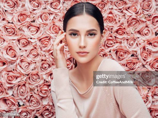 beautiful woman with curly hair - beautiful woman roses stock pictures, royalty-free photos & images