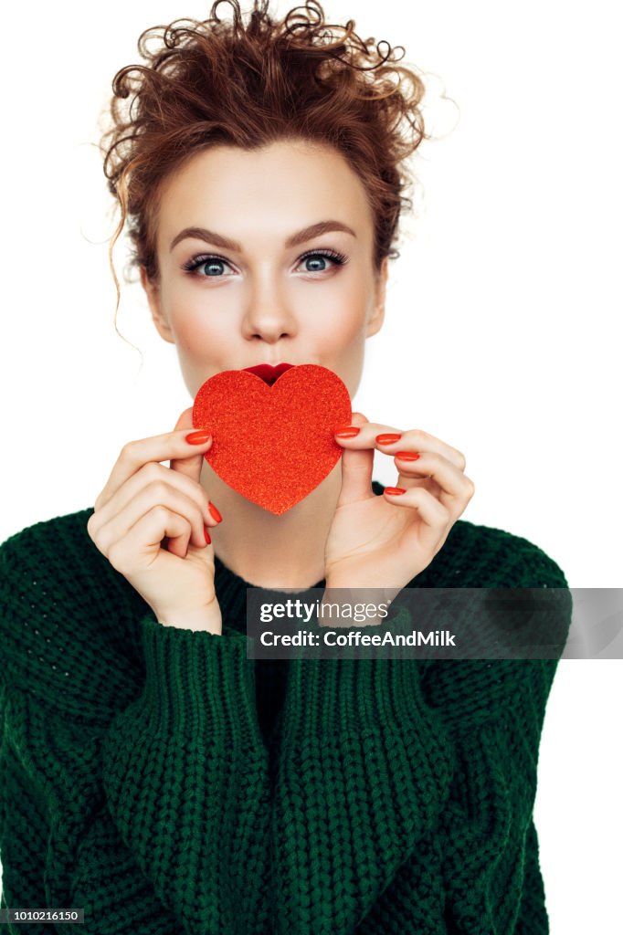 Smiling woman with paper heart