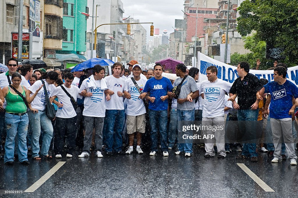 Students march under the rain during a p