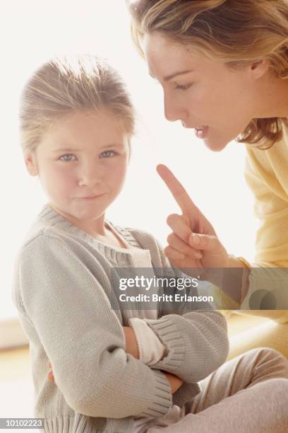 mother disciplining daughter - bossy stock pictures, royalty-free photos & images