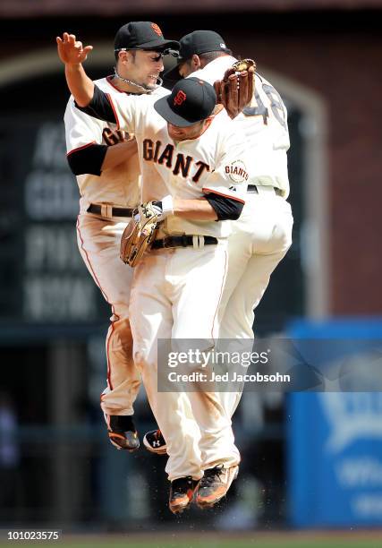 Freddy Sanchez, Andres Torres and Pablo Sandoval of the San Francisco Giants celebrate after defeating the Washington Nationals during an MLB game at...