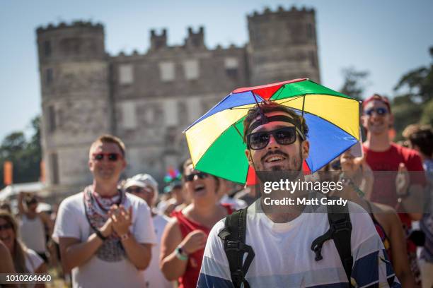 People watch a band on the main stage at Bestival, at Lulworth Castle near East Lulworth on August 3, 2018 in Dorset, England. The recent heatwave...