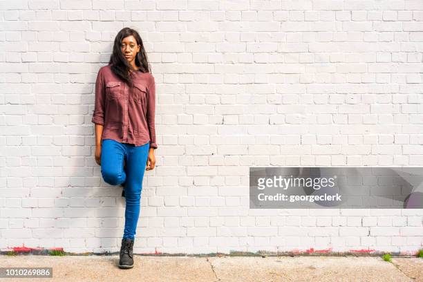 young woman - full length portrait - brick wall close up stock pictures, royalty-free photos & images