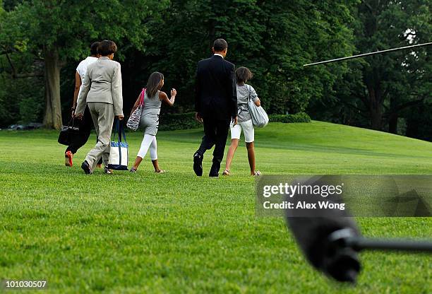 President Barack Obama walks with first lady Michelle Obama , daughters Malia Obama and Sasha Obama , and the first lady's mother Marian Robinson on...