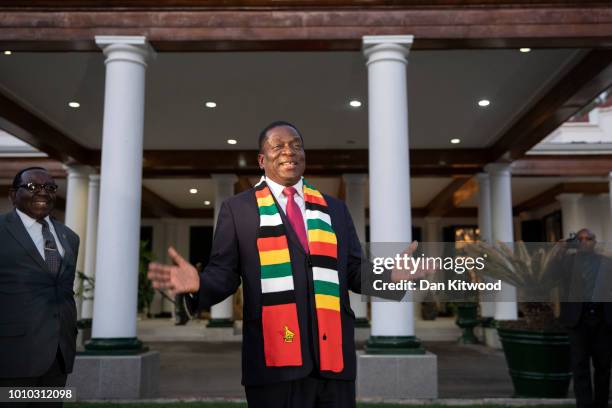 President-elect Emmerson Mnangagwa steps onto the lawn to pose for photographs after attending a press conference on August 3, 2018 in Harare,...