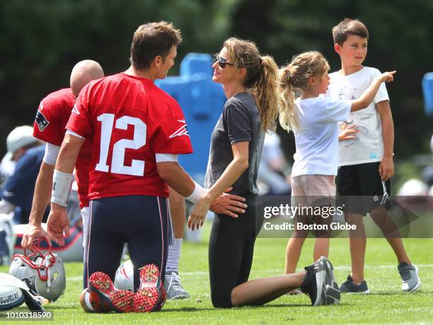 New England Patriots quarterback Tom Brady chats with his wife Gisele Bundchen as his daughter Vivian and son Benjamin, right, talk with each other...