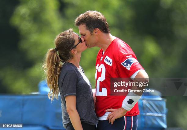 New England Patriots quarterback Tom Brady kisses his wife Gisele Bundchen following Patriots training camp at the Gillette Stadium practice facility...