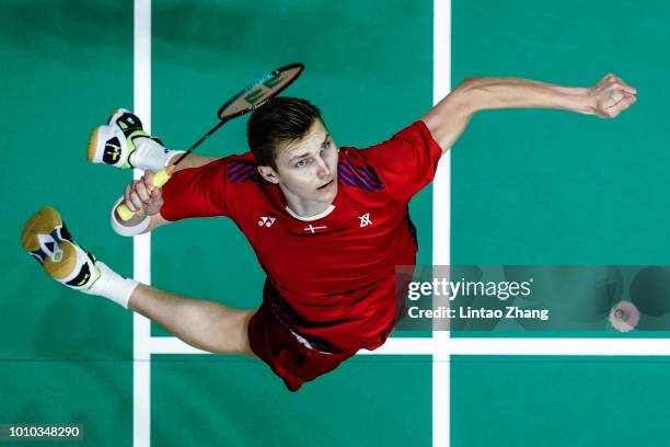 Viktor Axelsen of Denmark hits a shot against Chen Long of China in their men's singles quarterfinals during the Badminton World Championships at...