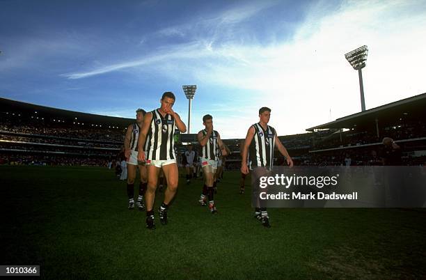 Jamie Tape, Shane Watson and Heath Scotland of the Collingwood Magpies walk off the pitch during the AFL Premiership Round 5 match against the...