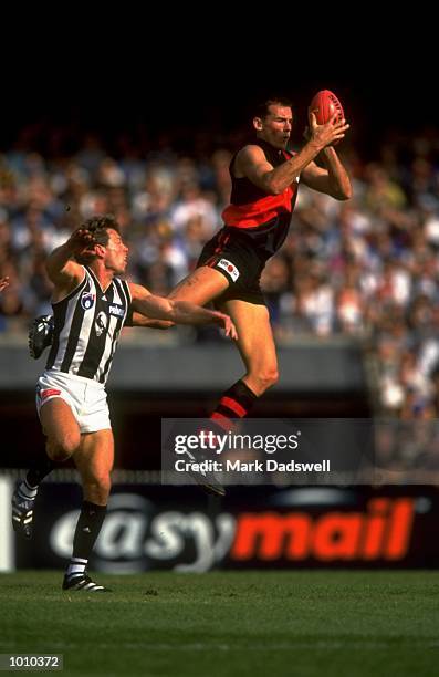 Simon Eastaugh of the Essendon Bombers comes off second best in this battle with Collingwood Magpie Gavin Brown, during the AFL Premiership Round 5...