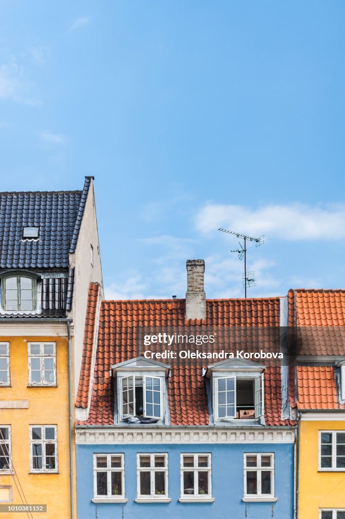 Scenic summer view of colorful building facades along the Nyhavn pier.