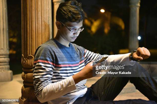 Teenager boy using mobile phone outdoor
