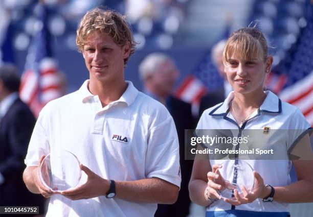 The Boys's Singles Champion David Nalbandian of Argentina and the Girls' Singles Champion Jelena Dokic of Australia pose with their trophies during...