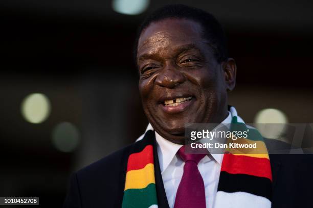 President Elect Emmerson Mnangagwa steps onto the lawn to pose for photographs after attending a press conference on August 3, 2018 in Harare,...