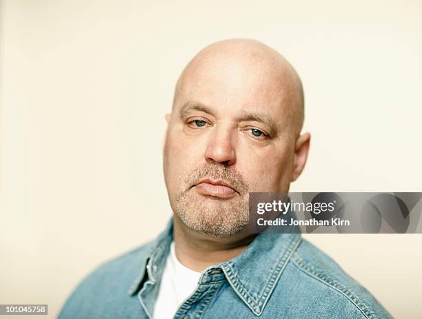mature man has a serious look.  - completely bald bildbanksfoton och bilder