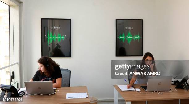 Sally and Serene listen to callers at Embrace, a suicide prevention helpline, in the Lebanese capital Beirut on July 13, 2018. - In Lebanon, mental...