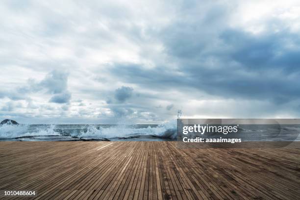 scenic view of waves crashing on beach - boardwalk stockfoto's en -beelden