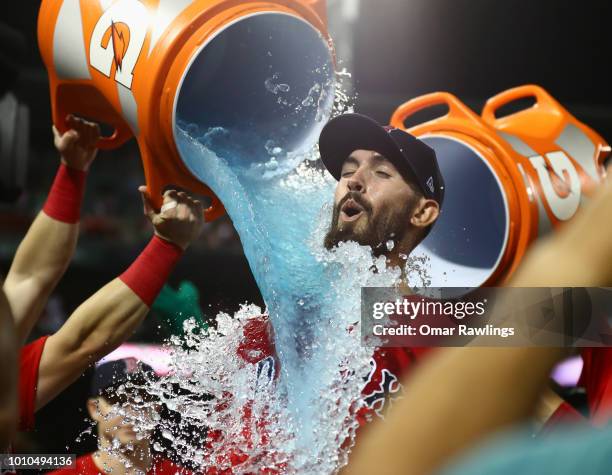 Rick Porcello of the Boston Red Sox gets a Gatorade bath from team mate Andrew Benintendi of the Boston Red Sox after the win over the New York...