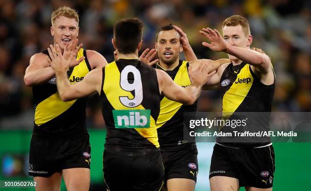 Trent Cotchin of the Tigers celebrates a goal with L-R Josh Caddy, Sam Lloyd and Jacob Townsend of the Tigers during the 2018 AFL round 20 match...