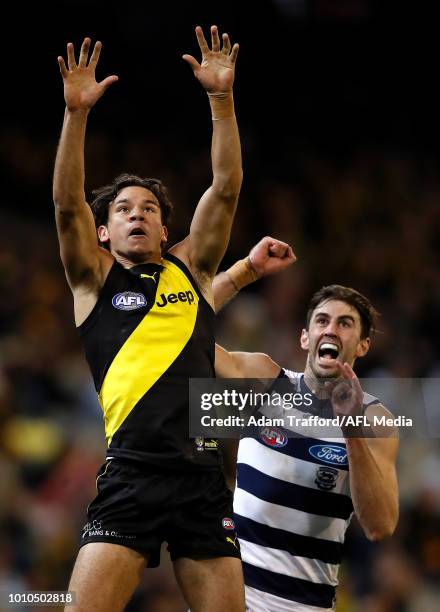 Daniel Rioli of the Tigers and Debutant, Ryan Abbott of the Cats compete for the ball during the 2018 AFL round 20 match between the Richmond Tigers...