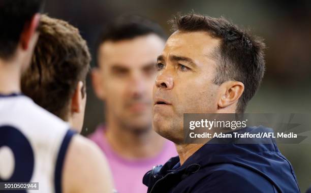 Chris Scott, Senior Coach of the Cats addresses his players during the 2018 AFL round 20 match between the Richmond Tigers and the Geelong Cats at...