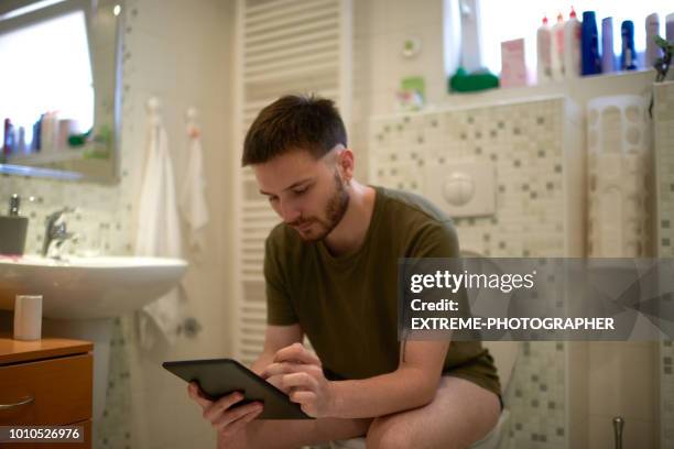 man on the toilet - toilet bowl bathroom stock pictures, royalty-free photos & images