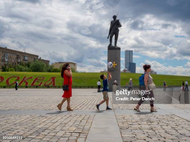 Visitor to Poklonnaya Hill plays with a football, one of Moscow's highest points, it's home to the Victory Park with World War II displays and a war...