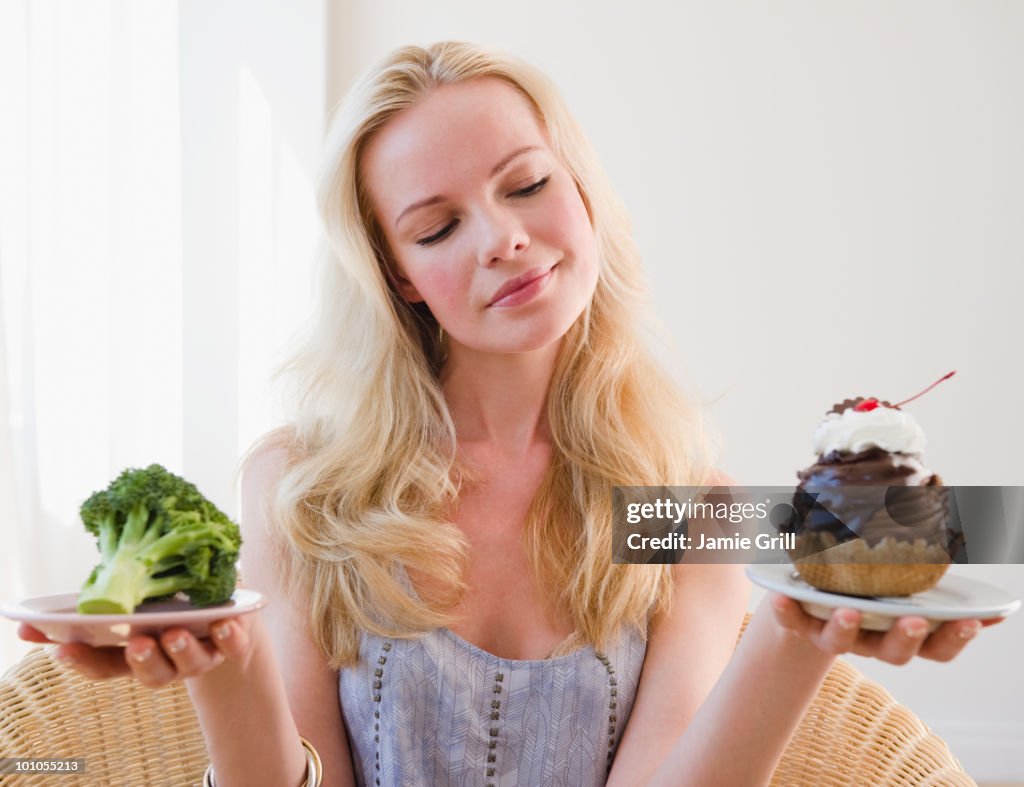 Woman choosing between broccoli or sundae