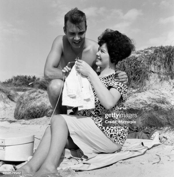 Pop singer Marty Wilde and his 19-year-old wife Joyce on the beach at Shell Bay, Dorset. They are living in Sandbanks while Marty is appearing at the...