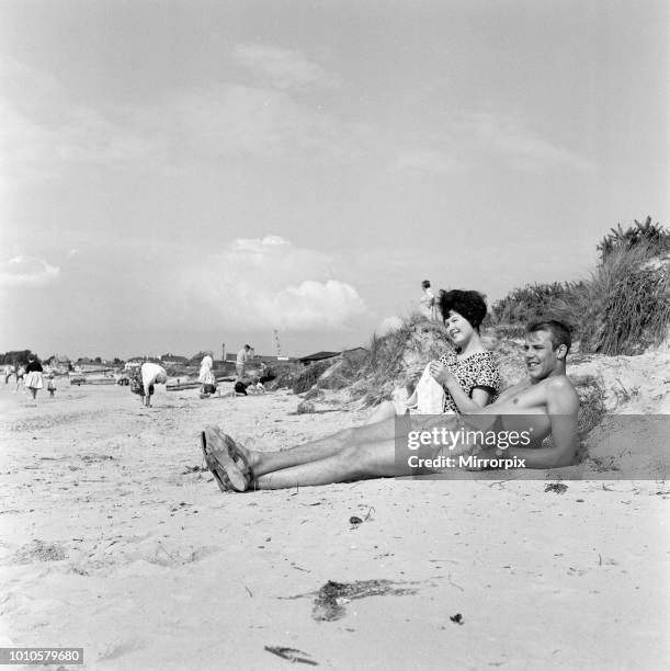 Pop singer Marty Wilde and his 19-year-old wife Joyce on the beach at Shell Bay, Dorset. They are living in Sandbanks while Marty is appearing at the...