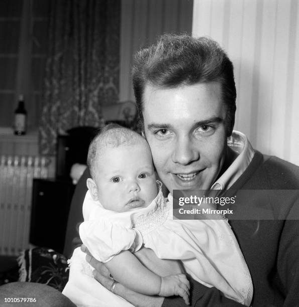 Singer Marty Wilde at home in Chiswick with his baby daughter Kim, 30th January 1961.