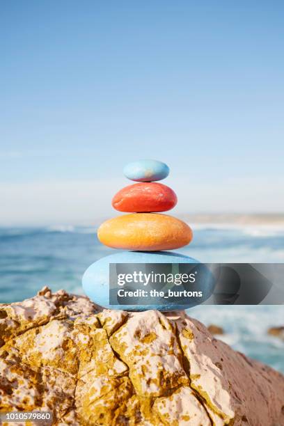 stack of colorful balanced stones at the sea - spirituality concept stock pictures, royalty-free photos & images