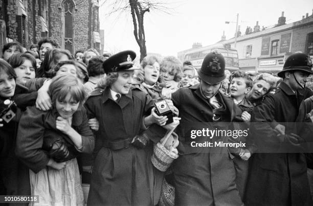 The wedding of Marty Wilde and Joyce Baker, held at Christ Church in Greenwich. Fans are held back by Police, 2nd December 1959.