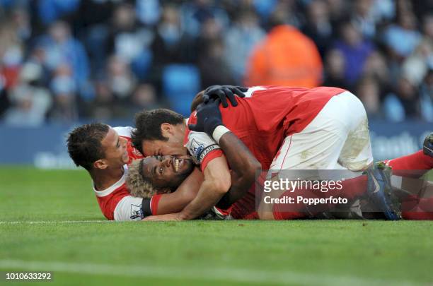Alex Song of Arsenal celebrates with teammates Cesc Fabregas and Marouane Chamakh after scoring their 2nd goal during the Barclays Premier League...